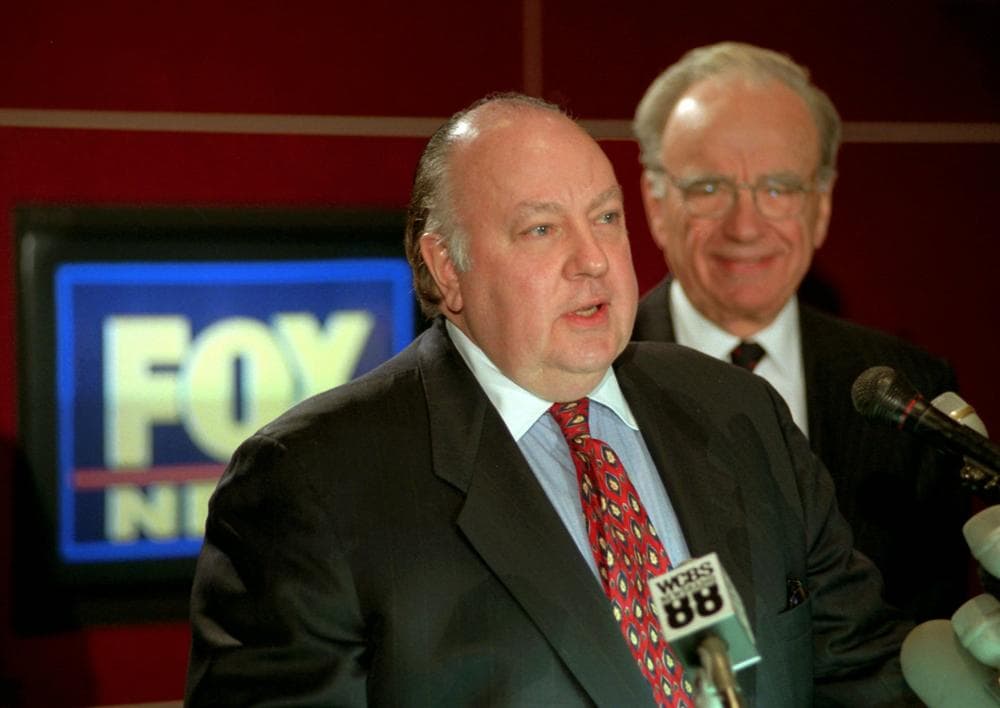 Roger Ailes, left, stands in front of News Corp. chief Rupert Murdoch at a conference after he was named chairman and CEO of News Corp.'s Fox News in 1996. (AP)