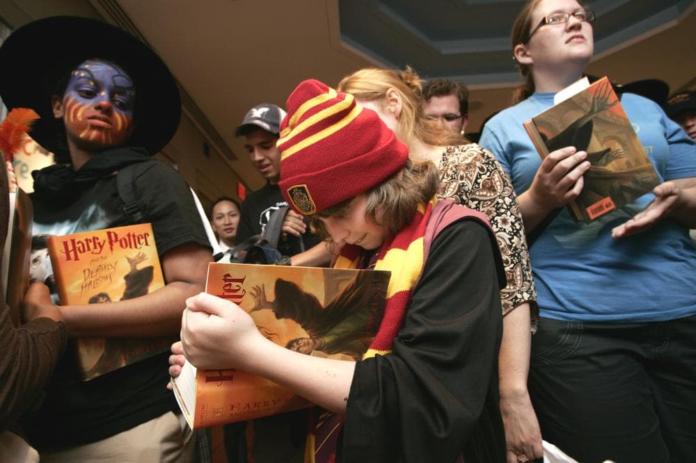 Fans look through some of the initial copies of Harry Potter and the Deathly Hallows during a book release party in New York, July 21, 2007. (AP/Courtesy of Scholastic, Inc.)