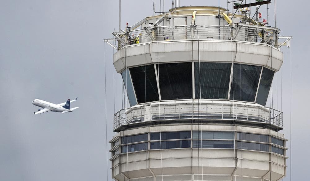A passenger jet flies past the FAA control tower at Washington's Ronald Reagan National Airport. (AP)
