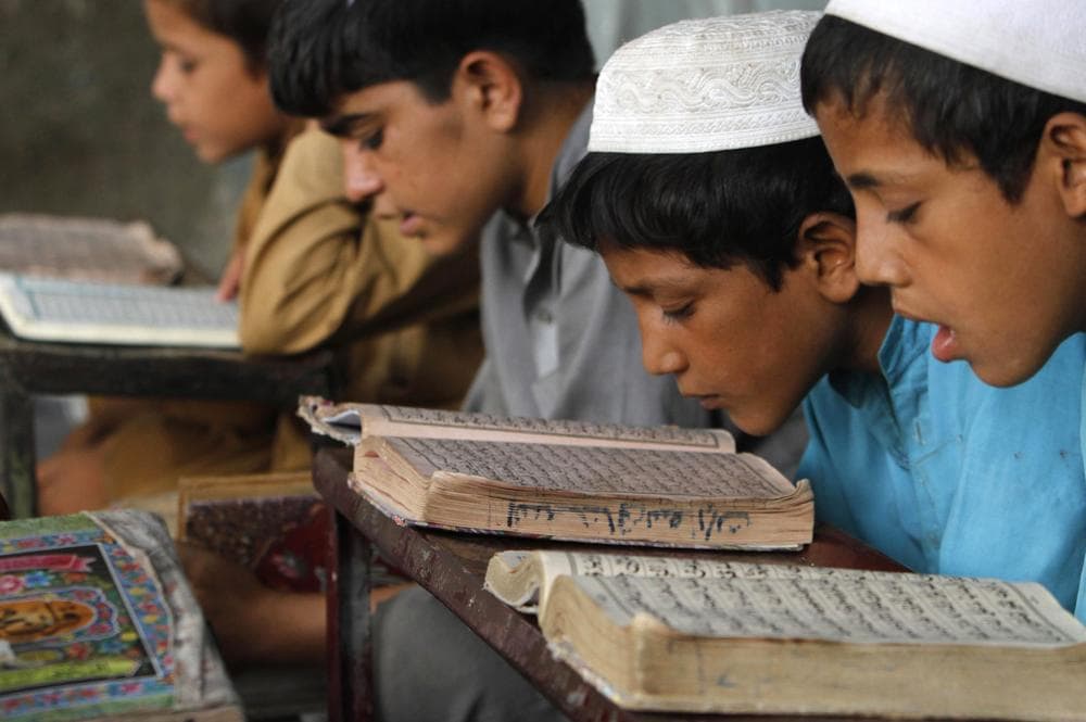 Afghan boys read the Quran during the Muslim holy month of Ramadan at a mosque in the city of Jalalabad, east of Kabul, Afghanistan. (AP)