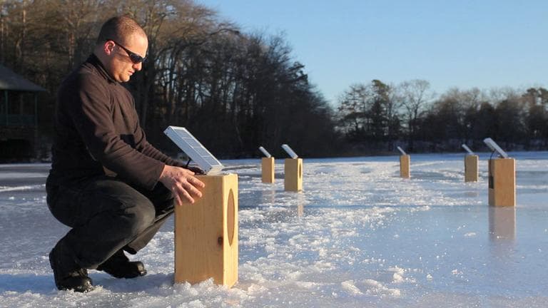 Artist Craig Colorusso arranges his &quot;Sun Boxes&quot; on a frozen pond in Plymouth in February. (Courtesy Kevin Belli)