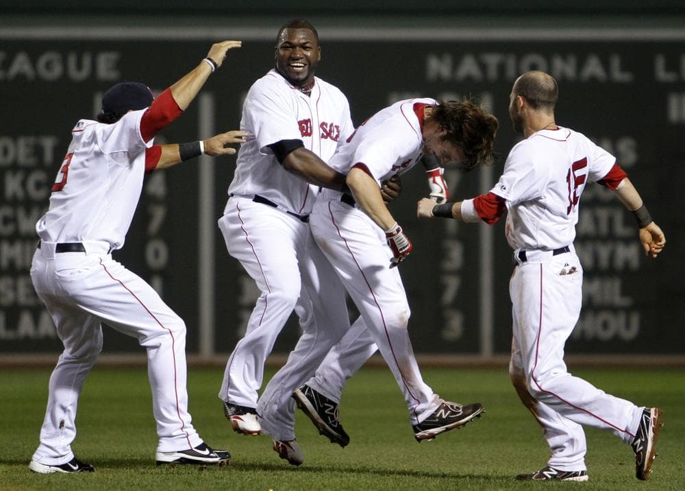 Boston&#039;s David Ortiz, second from left, lifts Josh Reddick, second from right, as Mike Aviles, left, and Dustin Pedroia, right, come in to celebrate after Reddick&#039;s RBI single gave the Red Sox the walk-off, 3-2 win against New York in the tenth inning of the game in Boston on Sunday. (AP)