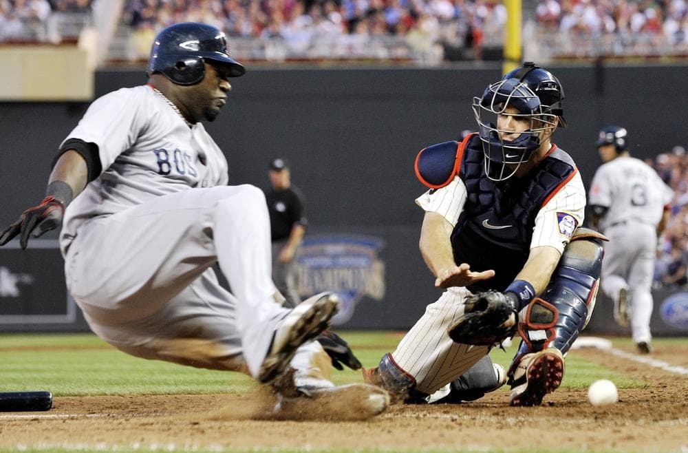 Boston&#039;s David Ortiz, left, comes in to score from third as Minnesota catcher Joe Mauer can&#039;t handle the throw on a fielders choice hit into by Mike Aviles in the eighth inning of the game on Monday in Minneapolis. (AP)