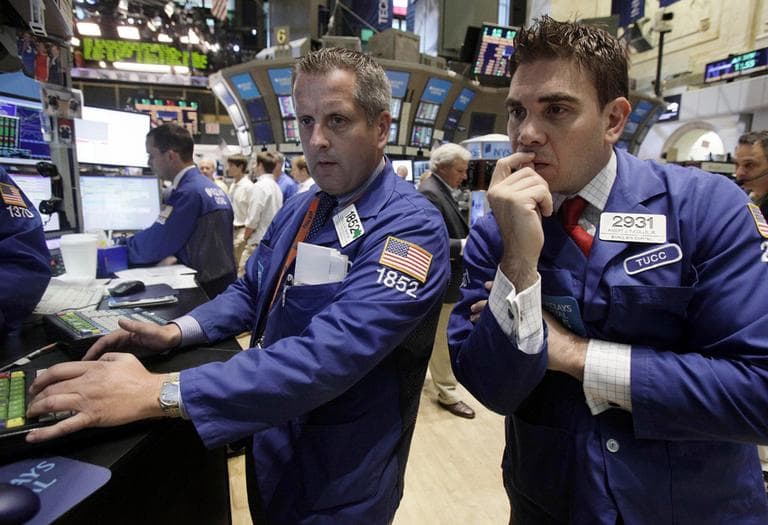 Specialists Donald Vaneck, center, and Robert Tuccillo work on the floor of the New York Stock Exchange Tuesday. (AP)