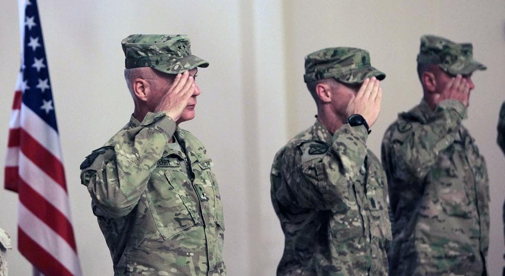 U.S Major General James L.Terry left,  Commander Regional Command South slautes as he along with other stand for American National anthem during a transfer of command authority ceremony in Kandahar airbase in Afghanistan. (AP)