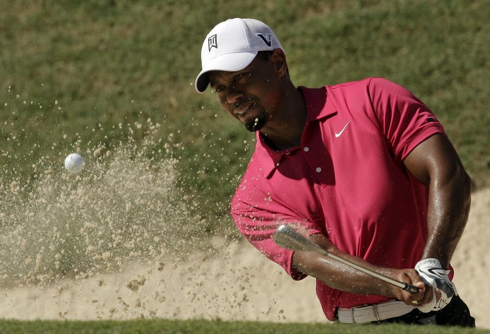 Tiger Woods hits out of a bunker during the first round of the PGA Championship golf tournament Thursday, in Johns Creek, Ga. (AP)