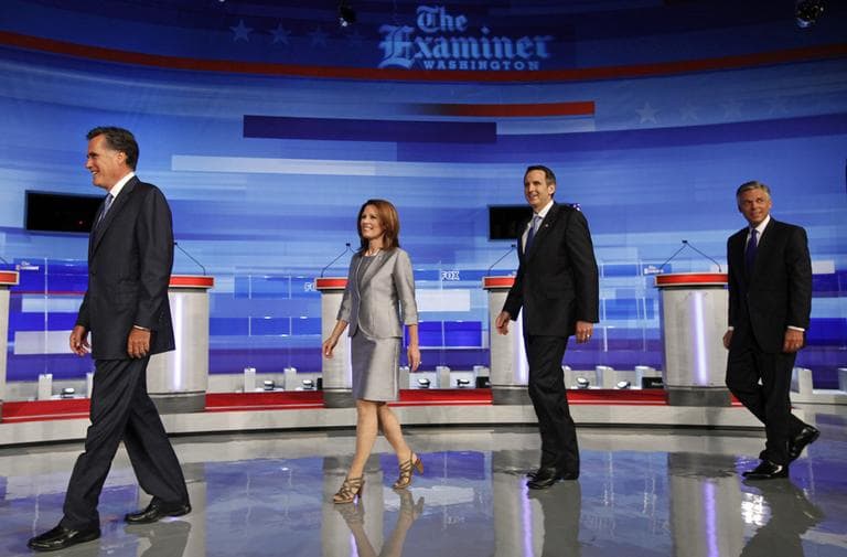 Republican presidential candidates including Mitt Romney, Michele Bachmann, Tim Pawlenty, and Jon Huntsman walk on stage for a photo before the start of the Iowa GOP/Fox News Debate in Ames, Iowa. (AP)