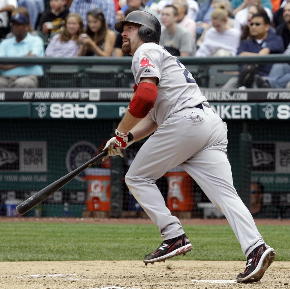 Boston&#39;s Kevin Youkilis watches his two-run home run in the eighth inning against Seattle on Sunday. (AP)
