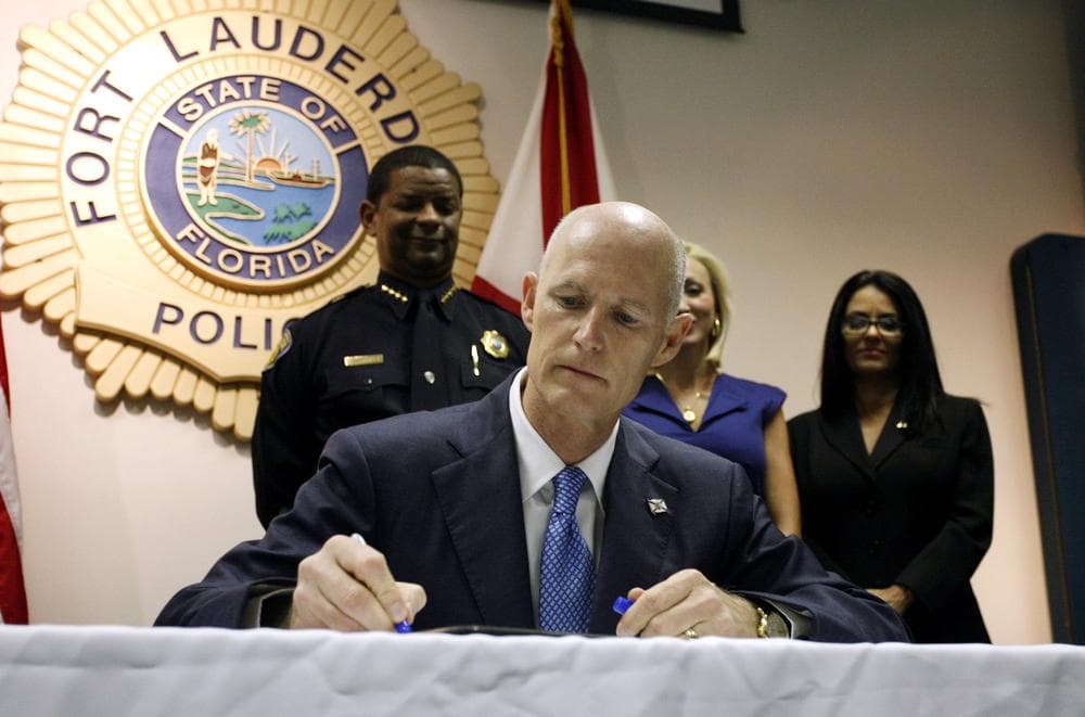 Florida Governor Rick Scott signs a law aimed at controlling the state's &quot;pill mills&quot; in June, 2011. (AP) 