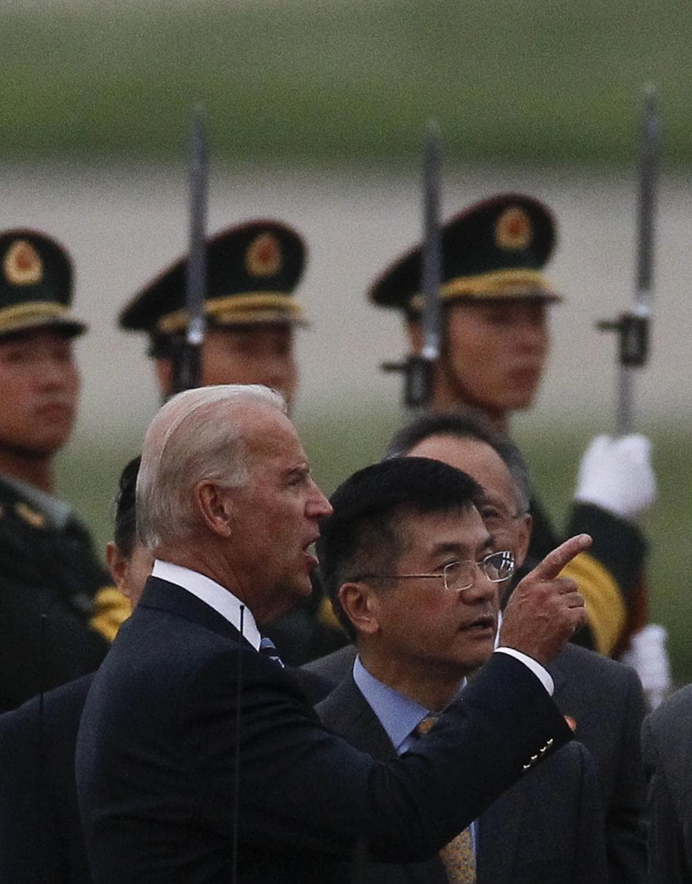 U.S. Vice President Joseph Biden, left, talks with U.S. Ambassador to China Gary Locke, right, after Biden's arrival  at the Capital International Airport in Beijing, China, Wednesday. (AP)