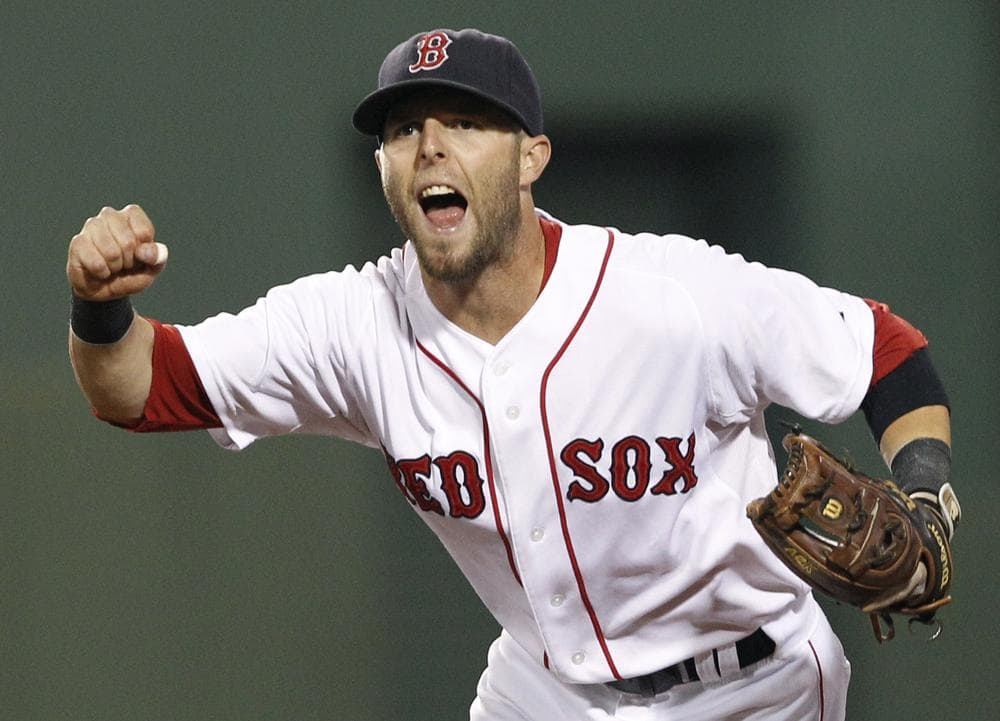 Boston Red Sox second baseman Dustin Pedroia celebrates the completion of a triple play against the Tampa Bay Rays during the fourth inning of the game of a doubleheader in Boston on Tuesday. Pedroia threw out Rays&#039; Sean Rodriguez at first to get the final out. (AP)