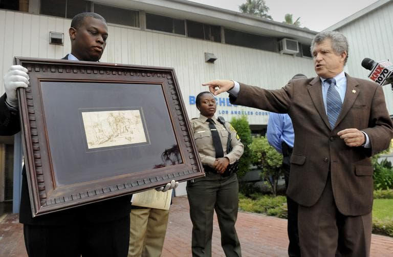 Los Angeles Sheriff detective Clarence Williams, left, and spokesman Steve Whitmore display the recovered $250,000 Rembrandt drawing known as &quot;The Judgment&quot;, Tuesday in Marina Del Rey, Calif. (AP)