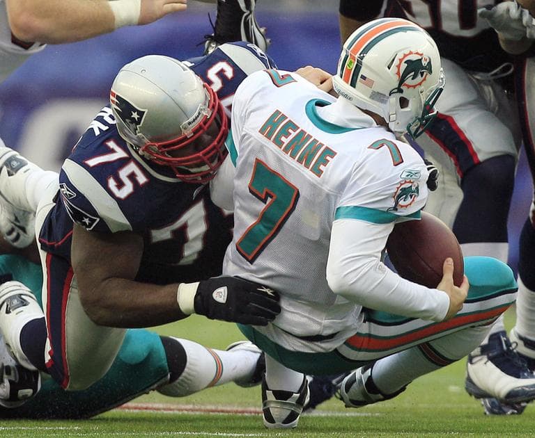 New England Patriots nose tackle Vince Wilfork, left, sacks Miami Dolphins quarterback Chad Henne (7) during a game in January. (AP)