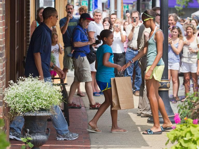President Obama, with daughters Malia, right, and Sasha, leave the Bunch of Grapes bookstore in Vineyard Haven Friday. (AP)