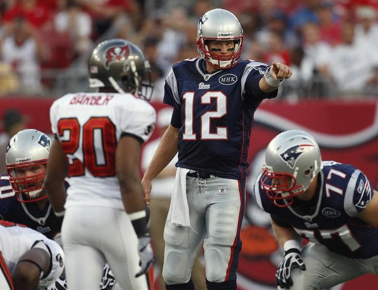 Patriots quarterback Tom Brady (12) runs the offense against Ronde Barber (20) and the Buccaneers Thursday in Tampa, Fla. (AP)