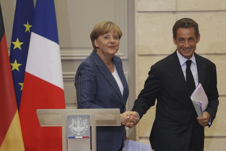 German Chancellor Angela Merkel, left, and France's President Nicolas Sarkozy, right, shake hands after their joint press conference at the Elysee Palace, Tuesday Aug. 16, 2011. (AP)