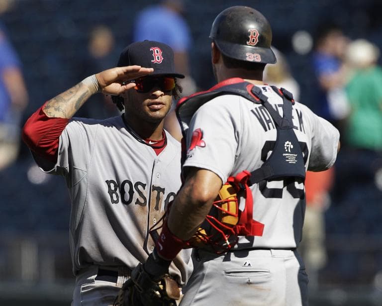 Sox left fielder Darnell McDonald, left, salutes catcher Jason Varitek after beating the Royals on Sunday. (AP)
