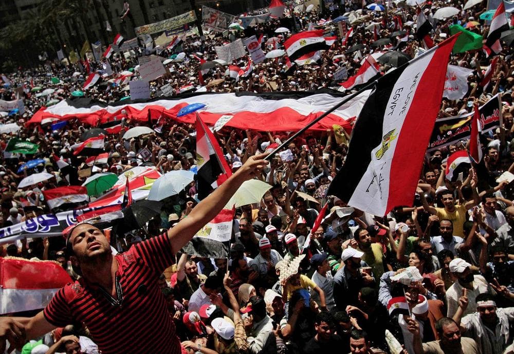 A protester waves an Egyptian flag that reads &quot;We Love Egypt&quot; during a demonstration after Friday prayers in Tahrir Square. 