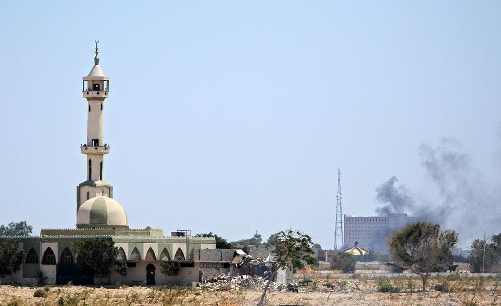 Smoke rises over buildings in the main compound of Moammar Gadhafi in the Bab Al-Aziziya district in Tripoli on Tuesday. (AP)