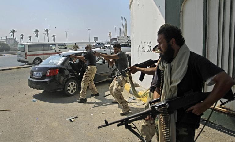 Libyan rebel fighters fire towards forces loyal to Moammar Gadhafi during fierce gunfire in downtown Tripoli, Libya, Monday, Aug. 22, 2011.  (AP)