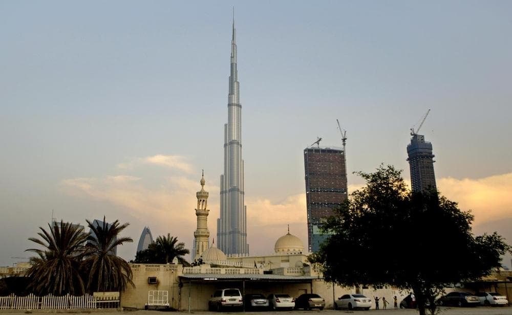 With World's tallest tower, Burj Khalifa in background, children play next to a mosque in Dubai, United Arab Emirates. (AP)