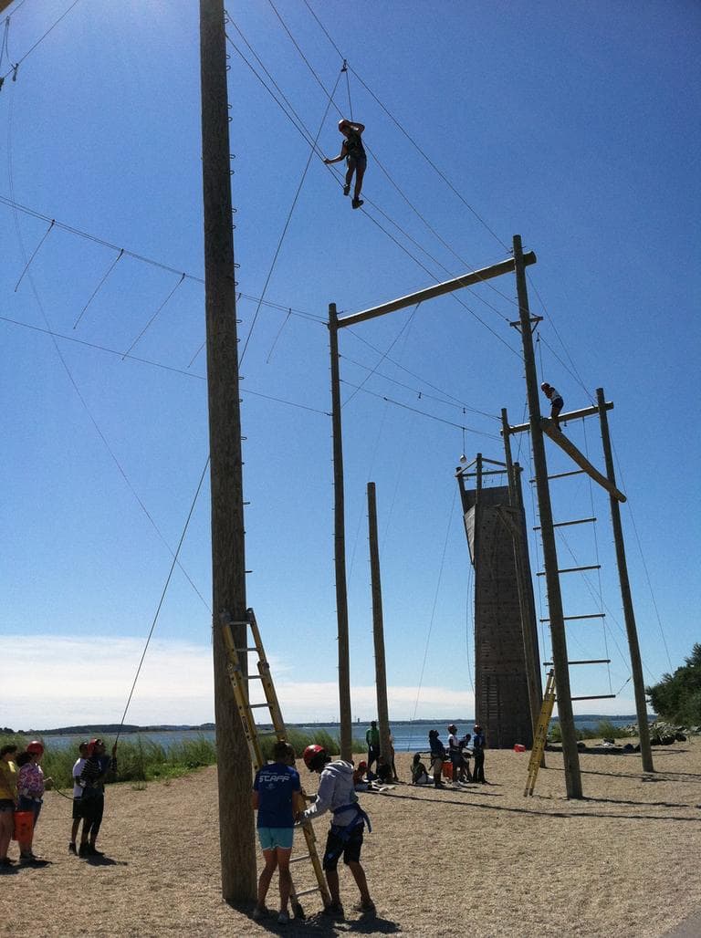 Children from the camp on a tightrope course (Delores Handy/WBUR)