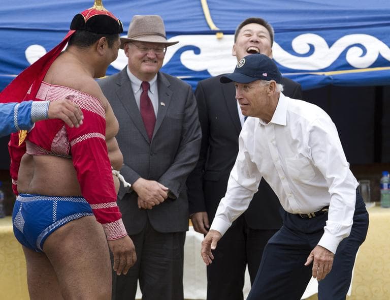 U.S. Vice President Joe Biden, right, meets Mongolian wrestler during Mini Nadam, or Mongolian wrestling performance, in Ulan Bator, Mongolia, Monday, Aug. 22, 2011. (AP Photo/Andy Wong)