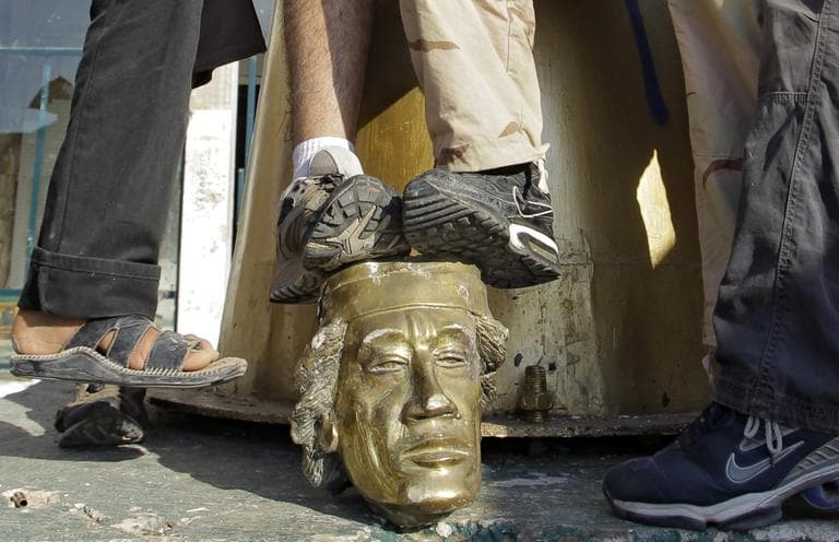 Rebel fighters trample on a head of Moammar Gadhafi inside the main compound in Bab al-Aziziya in Tripoli, LIbya, Tuesday, Aug. 23, 2011.  (AP)