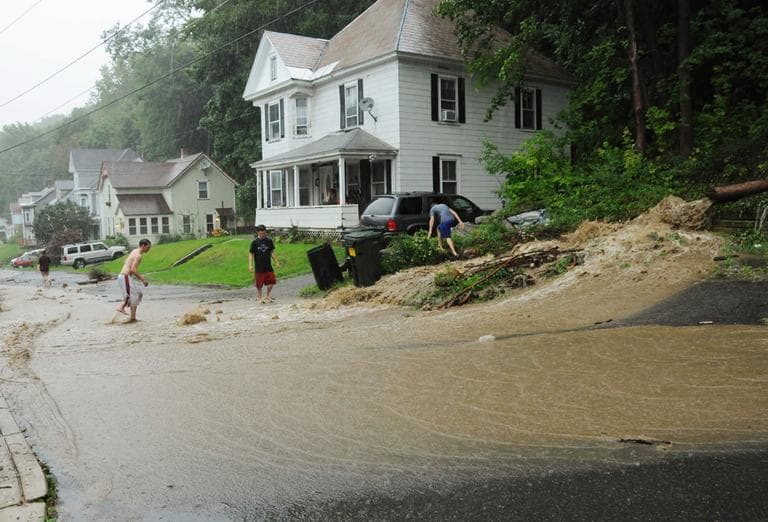 In this photo provided by Gregory Scheckler, floodwaters caused by Tropical Storm Irene rush down a street in North Adams, Mass., Sunday. (AP)