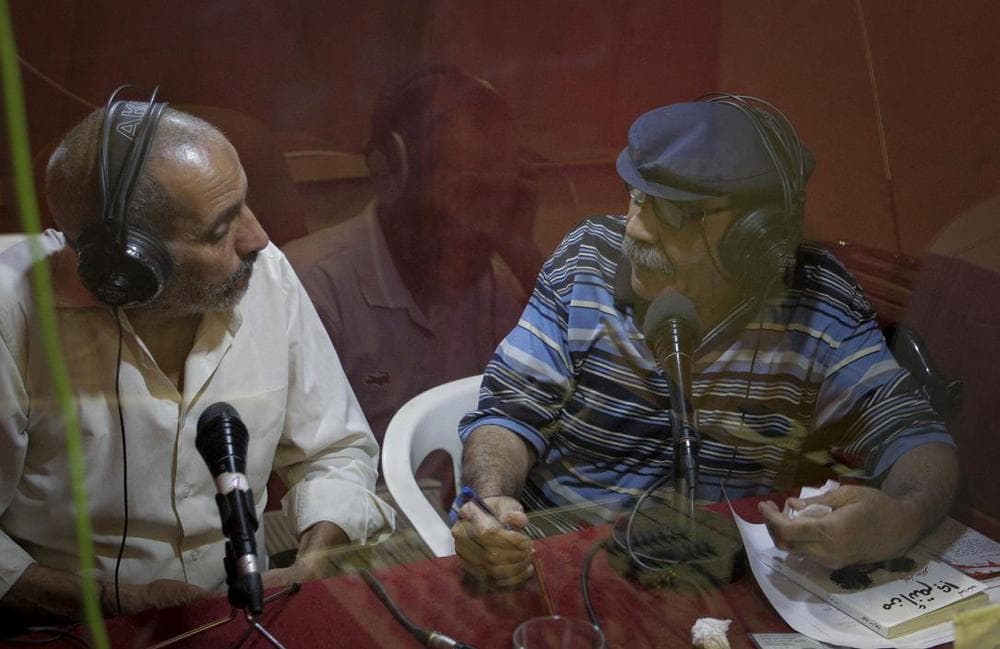 Journalists seen inside the Voice of Free Libya radio station studio in the rebel-held town of Benghazi, Libya. (AP)