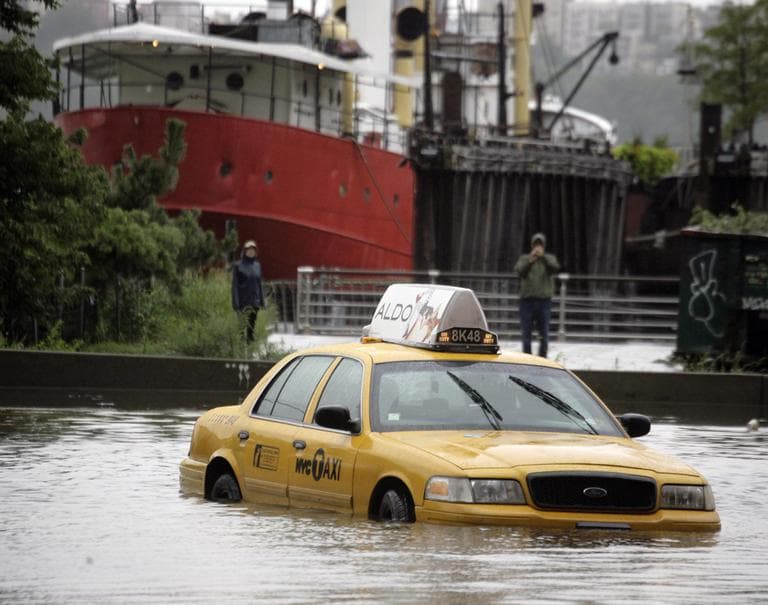 A New York City taxi is stranded in deep water on Manhattan's West Side as Tropical Storm Irene passes through the city, Sunday, Aug. 28, 2011 in New York. Although downgraded from a hurricane to a tropical storm, Irene's torrential rain couple with high winds and tides worked in concert to flood parts of the city. (AP)