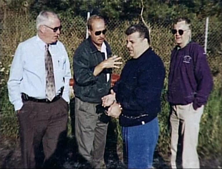 2005 file photo of Kevin Weeks, third from left, showing a burial site of alleged murder victims to, left to right: Col. Tom Foley, Mass. State Police; Daniel Doherty, DEA; and Lt. Steve Johnson, Mass. State Police (David Boeri/WBUR)