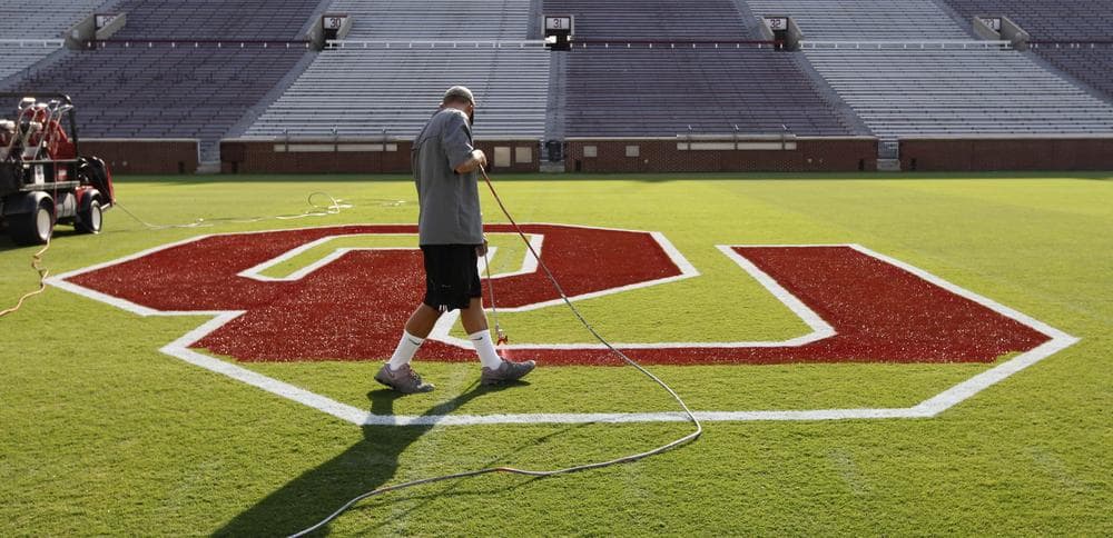 Oklahoma is ranked number one going into this football season. A worker finishes prepping the OU at the center of Owen Field as the team prepares for its season opener on Saturday against Tulsa. (AP)