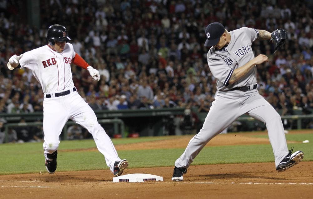 New York Yankees starting pitcher A.J. Burnett misses the bag as the Sox's Jacoby Ellsbury is safe at first. (AP)