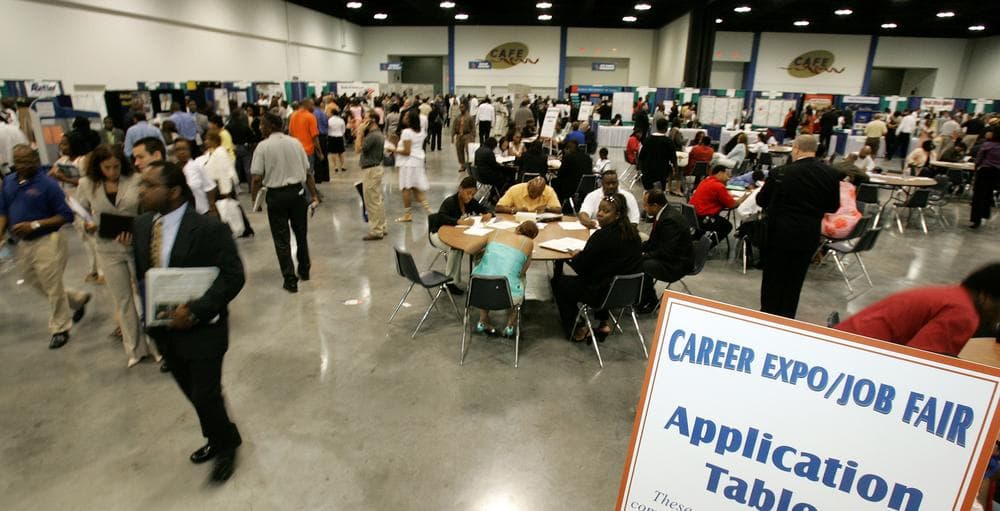 Attendees walk to company booths at a Georgia Department of Labor job fair. (AP)