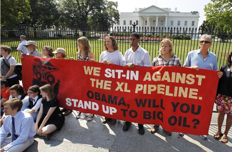 Activists protest a proposed pipeline to bring tar sands oil to the U.S. from Canada, gather in front of the White House in Washington, Saturday, Aug. 20, 2011. (AP)