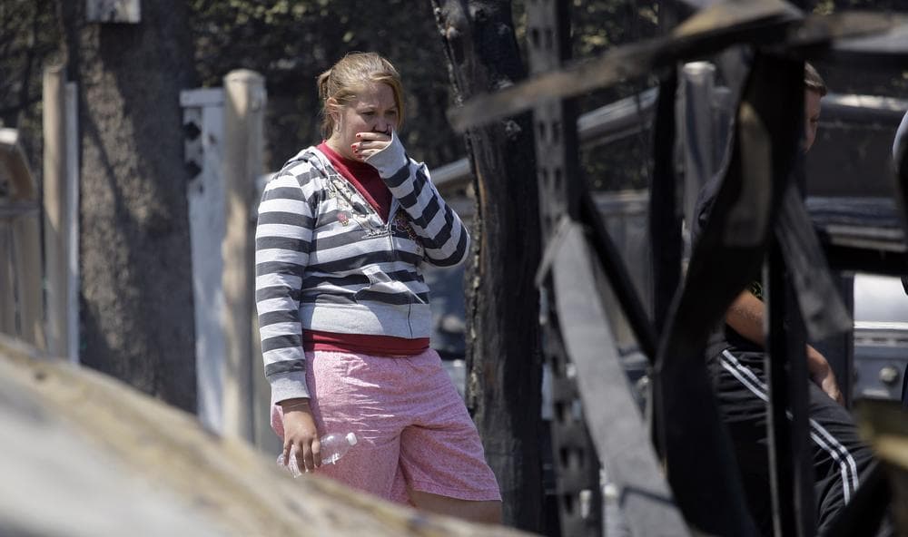 Laura Clements surveys her fire-destroyed home in Bastrop, Texas. The Clements lost their home to fires Monday.  (AP)