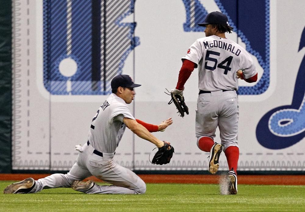 Sox center fielder Jacoby Ellsbury and right fielder Darnell McDonald can't catch up to a hit by the Rays' Desmond Jennings that resulted in a triple during the eleventh inning of last Saturday's game. The Rays won 6-5. (AP)