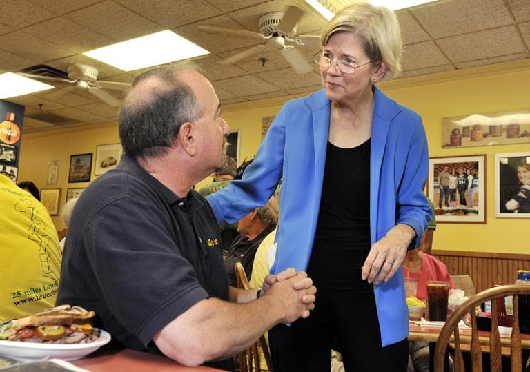 Democrat Elizabeth Warren, right, a Harvard Law professor and consumer advocate, speaks with voters in Framingham, Wednesday. (AP)
