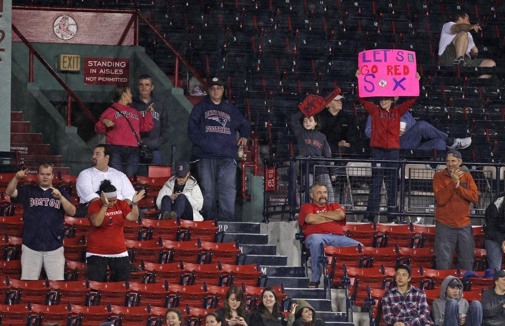 Red Sox fans cheer from nearly empty stands at Fenway Park on Thursday as the Rays beat the Sox 9-2. (AP)