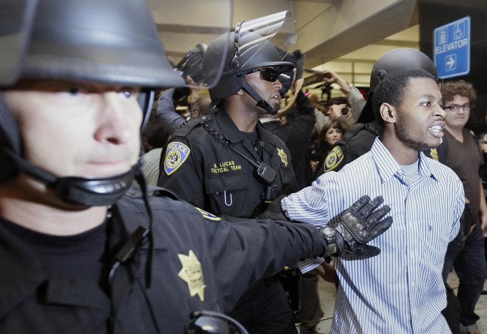 Bay Area Rapid Transit (BART) police officers arrest a man during a protest at the Civic Center train station in San Francisco. (AP)
