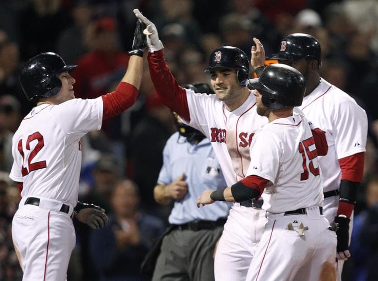 Boston Red Sox&#039;s Conor Jackson, second from left, is congratulated by teammates after his grand slam against the Baltimore Orioles at Fenway Park in Boston, Monday. (AP)