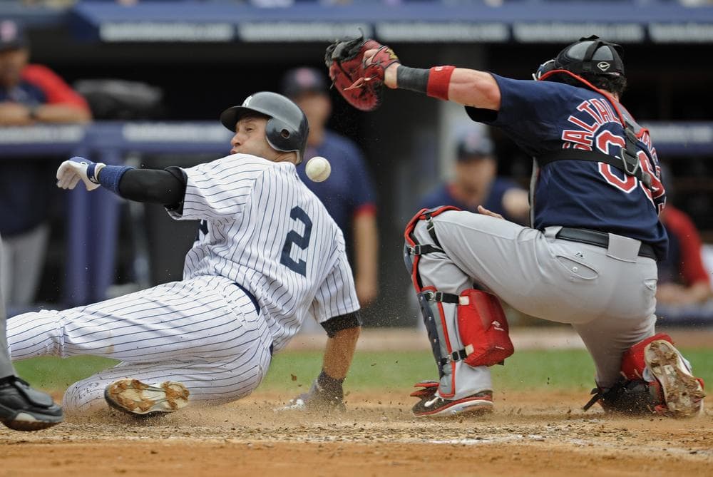 New York Yankees runner Derek Jeter, left, scores on a single by Alex Rodriguez, Sunday. (AP)
