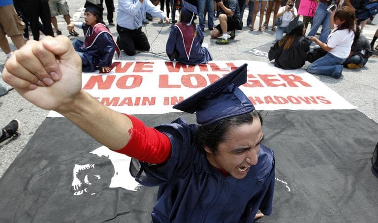 A protester blocks a street during a rally protesting Georgia's new immigration law on the Capitol steps Monday, June 28, 2011 in Atlanta.  (AP)