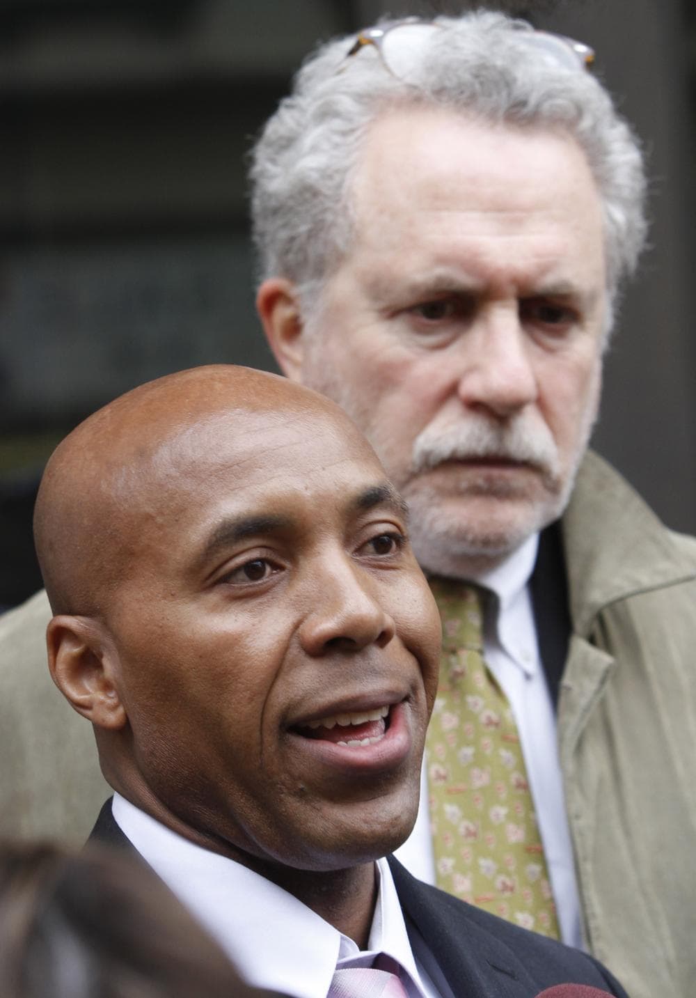 Thomas Haynesworth, front, who spent 27 years in prison, speaks to the media as his attorney Peter Neufeld leaves the Virginia Court of Appeals in March. (AP)