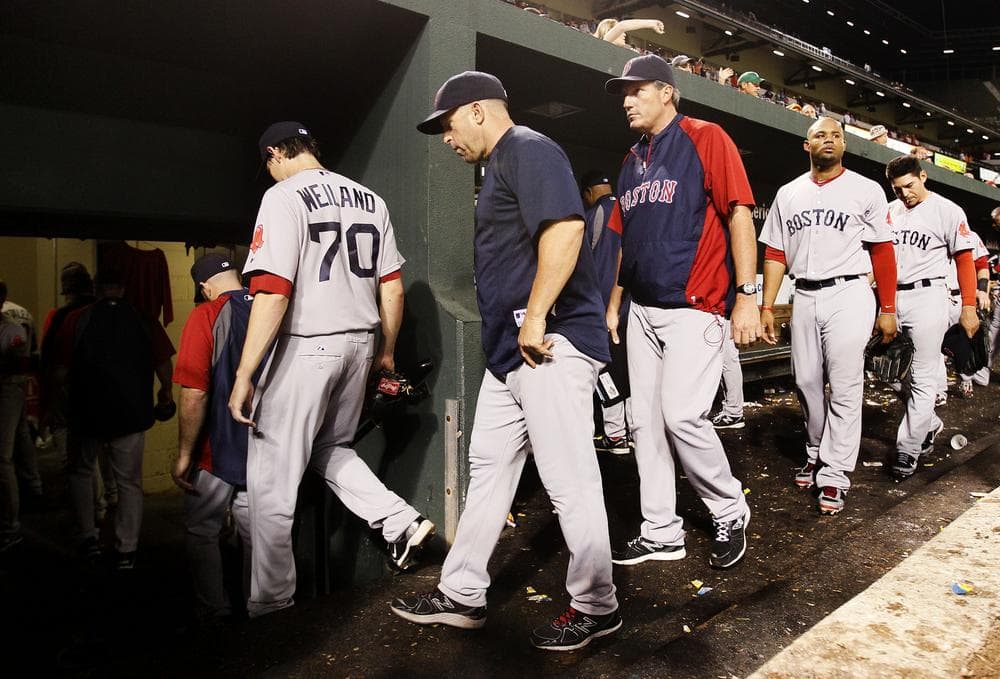 Members of the Boston Red Sox walk into the clubhouse after losing 6-3 to the Baltimore Orioles on Monday, Sept. 26, 2011, in Baltimore. (AP)