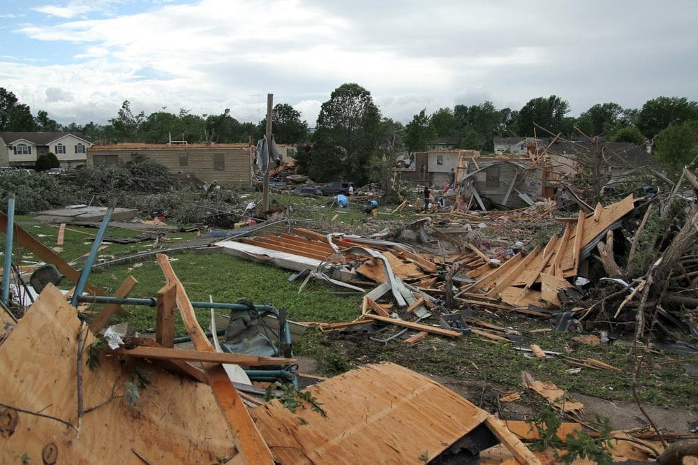 People pick through the debris in the wreckage of homes damaged by a tornado in Sedalia, Mo., in May, 2011. (AP)