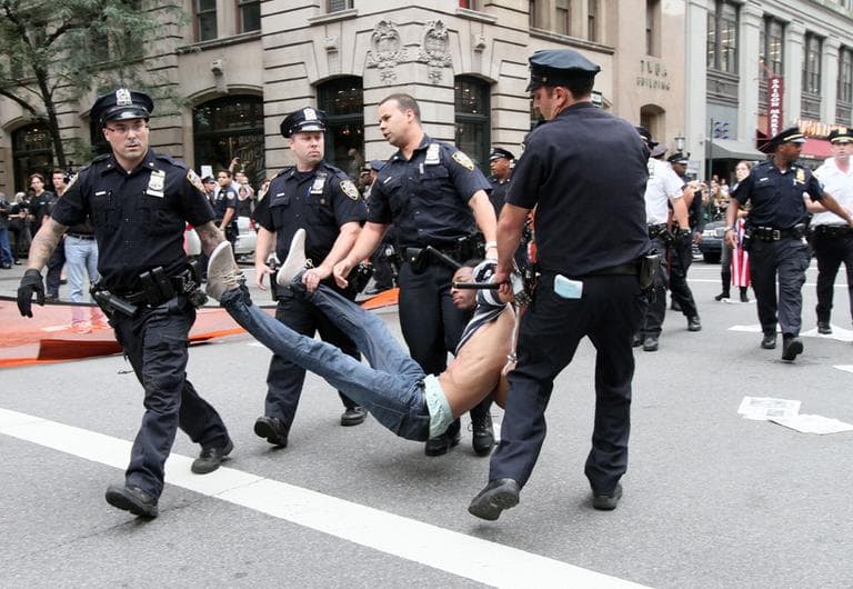 Police carry away a participant in a march organized by Occupy Wall Street in New York on Saturday Sept. 24, 2011. Marchers represented various political and economic causes. (AP)
