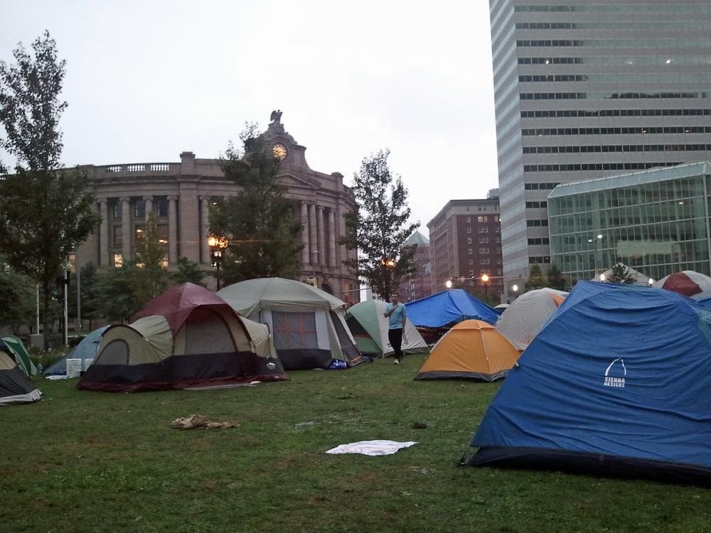 &quot;Occupy Boston&quot; protesters waking up in Dewey Square, outside of South Station, on Saturday. (Kathleen McNerney/WBUR)