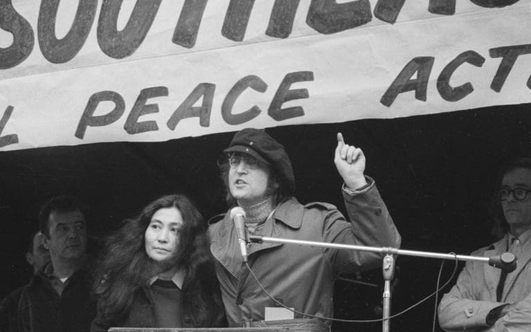 Former Beatle John Lennon, right, gestures as he speaks at a peace rally in New York's Bryant Park on April 22, 1972. Standing beside him is his wife, Yoko Ono. The rally and march of some 30,000 persons in New York City is part of a nationwide day of protests and demonstrations against U.S. involvement in the Vietnam War. (AP)